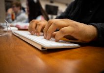  Hands typing on a keyboard